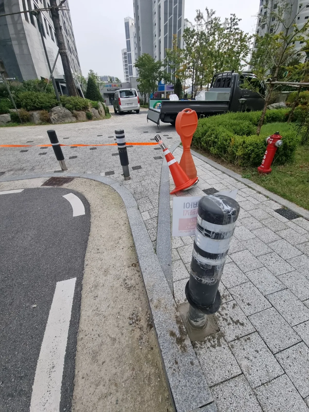 보도 경계석 옆에 새로 박아 넣은 볼라드 매립식·고정식 차단봉(볼라드) 설치 — 보도 경계석 옆에 새로 박아 넣은 볼라드
